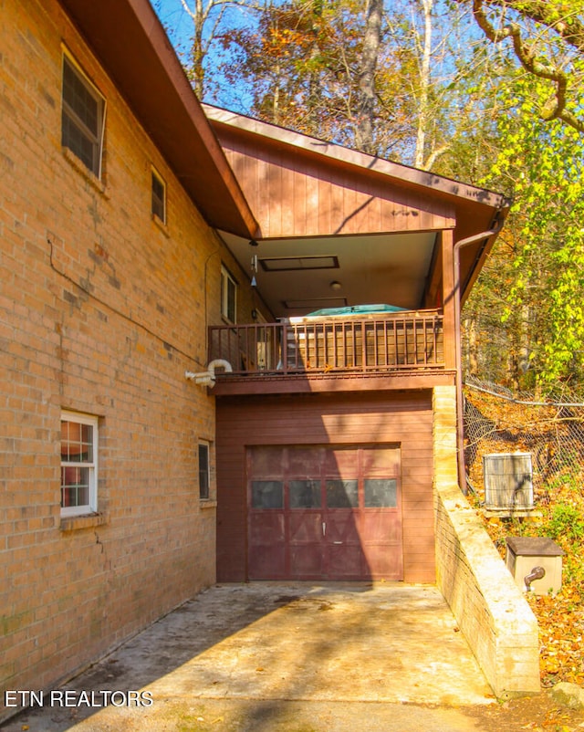 view of side of property with a balcony and a garage