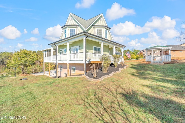 rear view of property featuring a yard