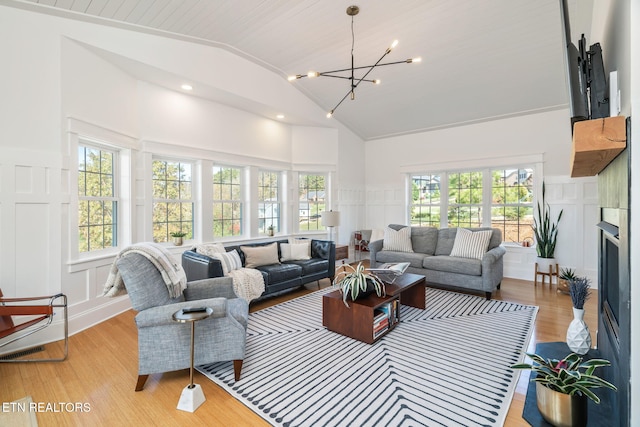 sunroom featuring vaulted ceiling and a chandelier