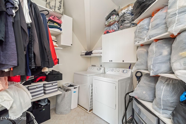 laundry area with cabinets and washer and clothes dryer