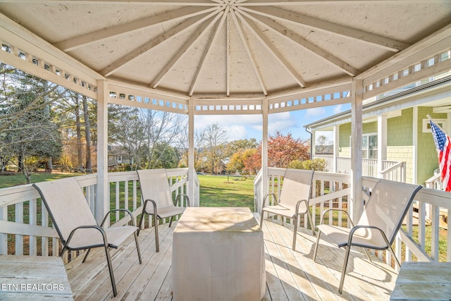 wooden deck featuring a gazebo and a lawn