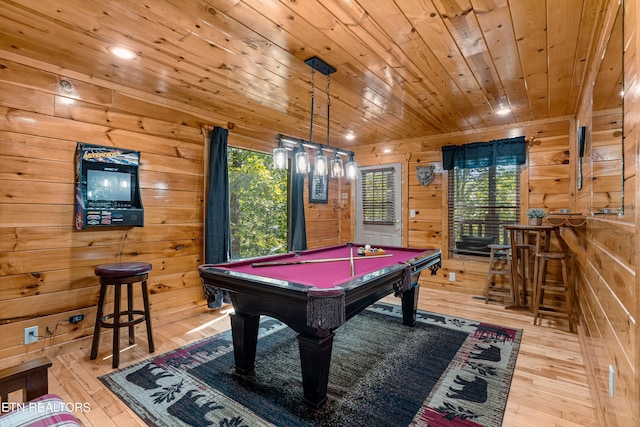 playroom featuring light wood-type flooring, wooden walls, wooden ceiling, and pool table