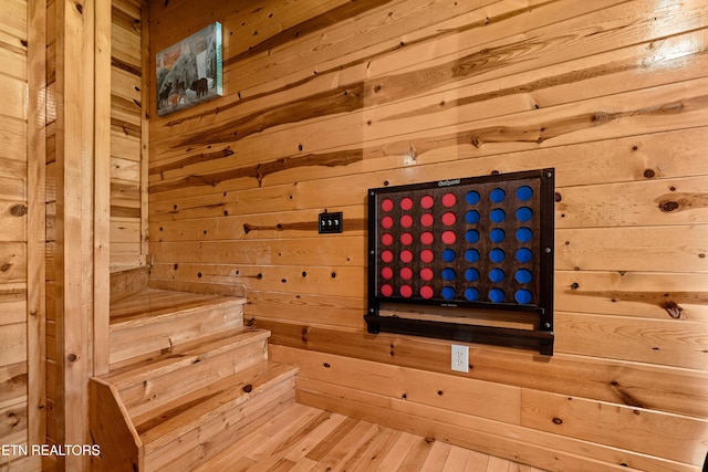 view of sauna with wood walls and hardwood / wood-style flooring