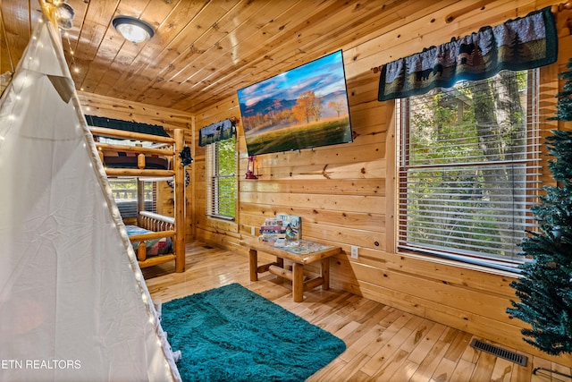 unfurnished bedroom featuring hardwood / wood-style floors, wood walls, and wood ceiling