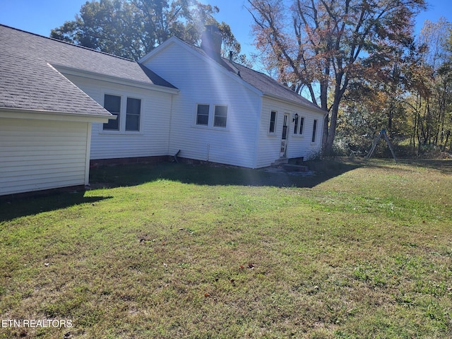 view of side of property with a lawn