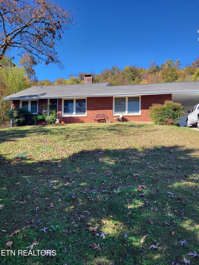 ranch-style home with a front lawn