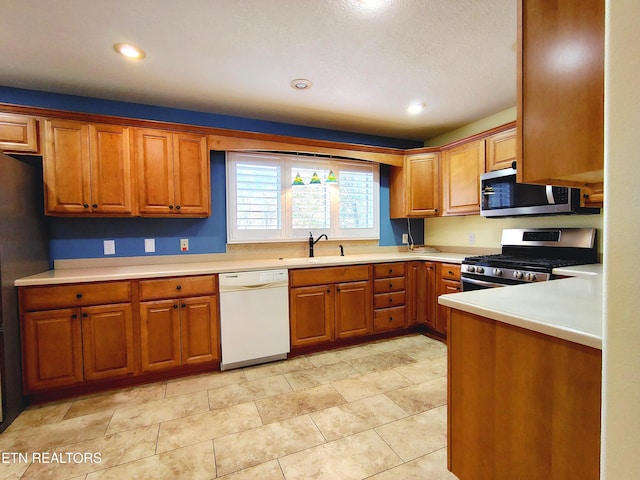 kitchen with appliances with stainless steel finishes and sink