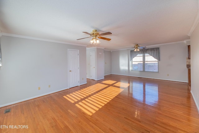 unfurnished room featuring ceiling fan, light wood-type flooring, and ornamental molding