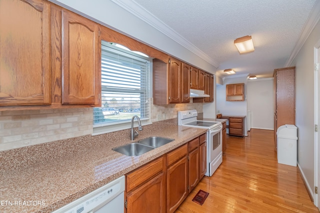 kitchen with sink, a textured ceiling, white appliances, decorative backsplash, and ornamental molding