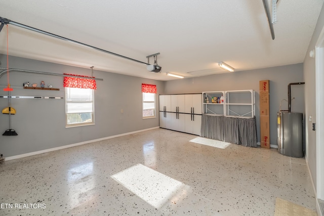 garage with a garage door opener and water heater