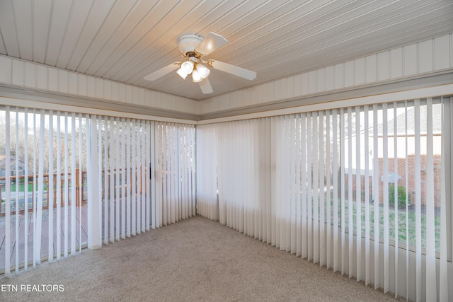 unfurnished room featuring ceiling fan and carpet floors