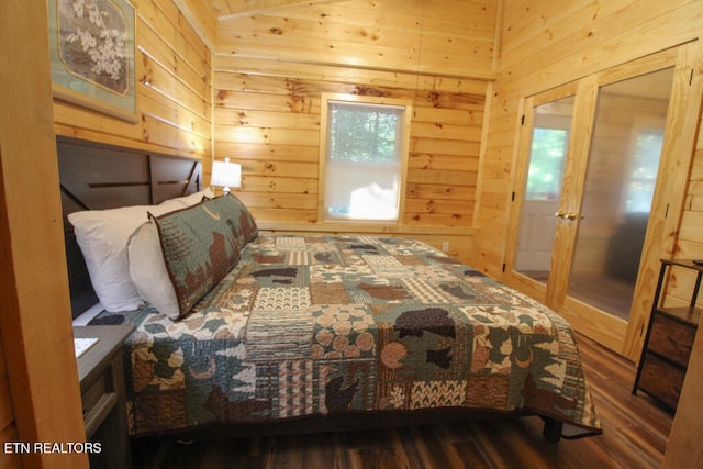 bedroom featuring wood-type flooring, multiple windows, and wood walls