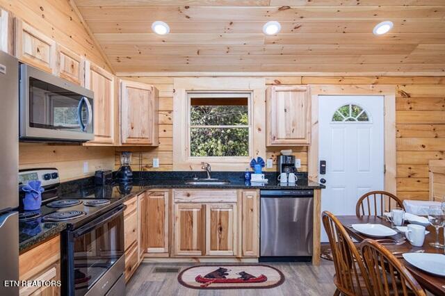 kitchen with appliances with stainless steel finishes, sink, wooden ceiling, hardwood / wood-style floors, and lofted ceiling