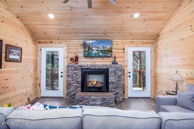 living room with hardwood / wood-style flooring, wooden ceiling, and vaulted ceiling