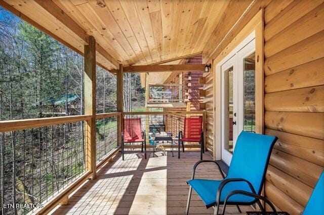 unfurnished sunroom featuring lofted ceiling and wood ceiling