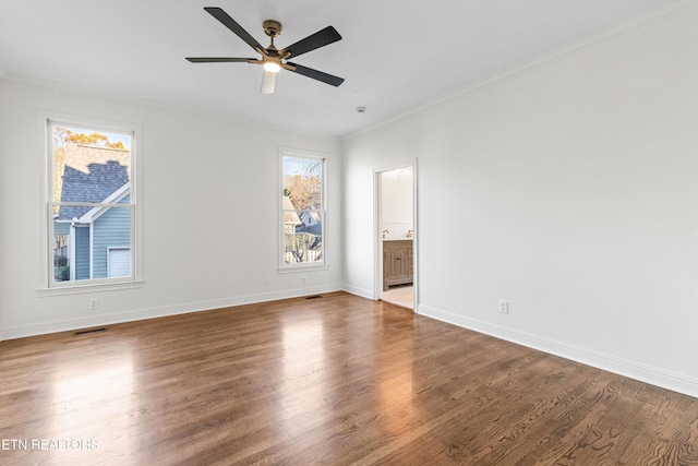 spare room featuring hardwood / wood-style flooring, ceiling fan, and crown molding