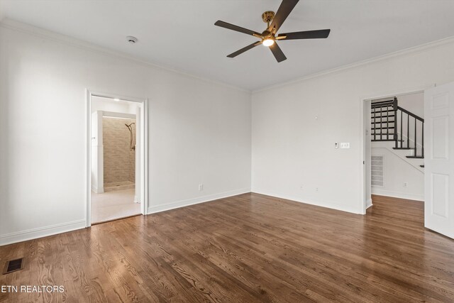 empty room featuring crown molding, dark hardwood / wood-style flooring, and ceiling fan