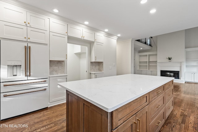 kitchen featuring white cabinetry, high end fridge, and dark hardwood / wood-style floors