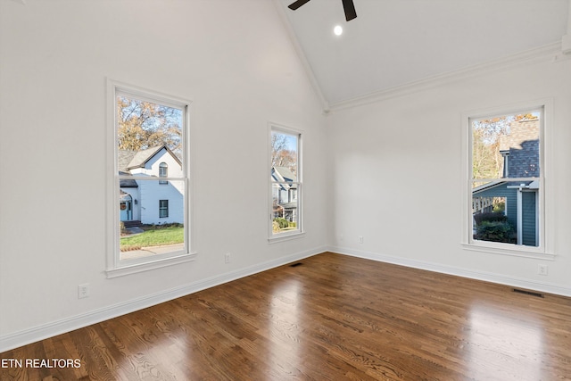 empty room with hardwood / wood-style floors and a healthy amount of sunlight