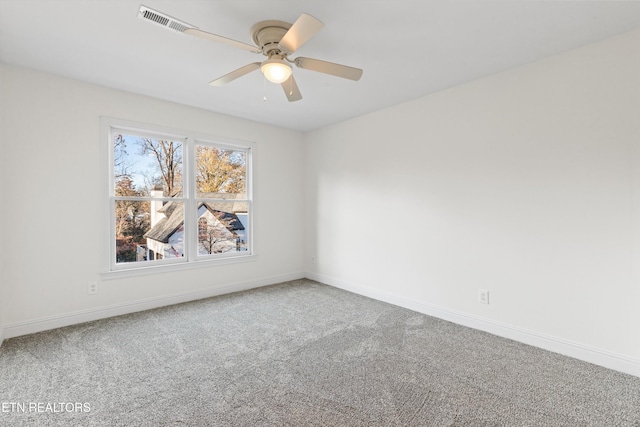 carpeted spare room featuring ceiling fan