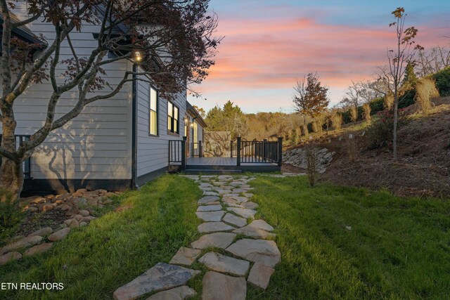 yard at dusk with a deck