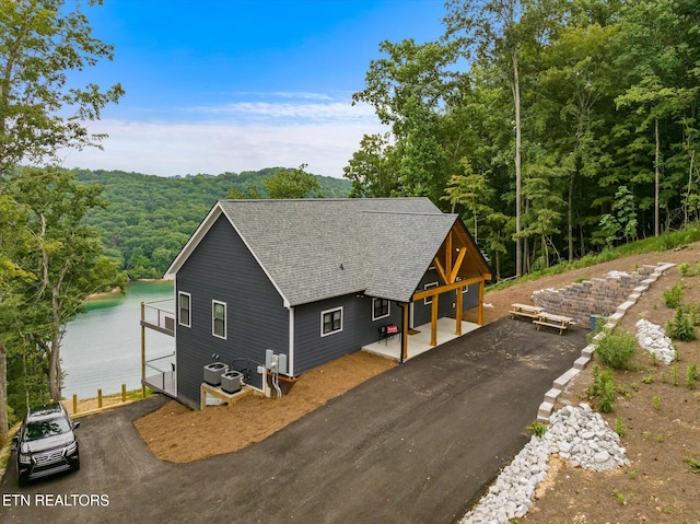 view of front of house with a water view