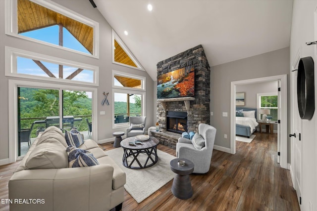 living room featuring dark wood-type flooring, a wealth of natural light, and high vaulted ceiling