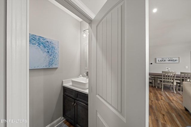 bathroom with hardwood / wood-style flooring and vanity