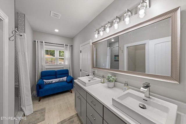 bathroom with hardwood / wood-style floors and vanity