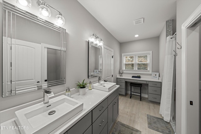 bathroom featuring vanity and hardwood / wood-style floors