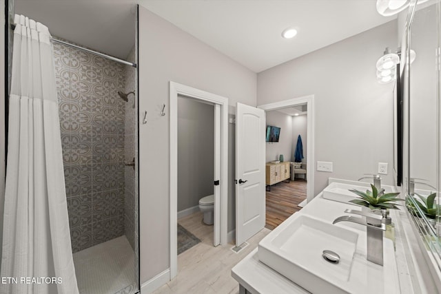 bathroom featuring vanity, hardwood / wood-style flooring, toilet, and a shower with curtain