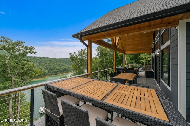 wooden terrace featuring a water view