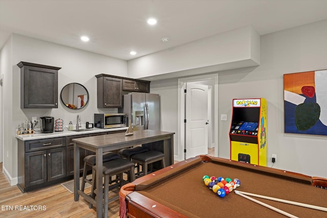 playroom with light wood-type flooring, sink, and billiards