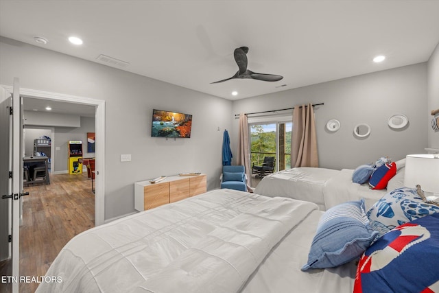 bedroom with hardwood / wood-style floors, access to outside, and ceiling fan