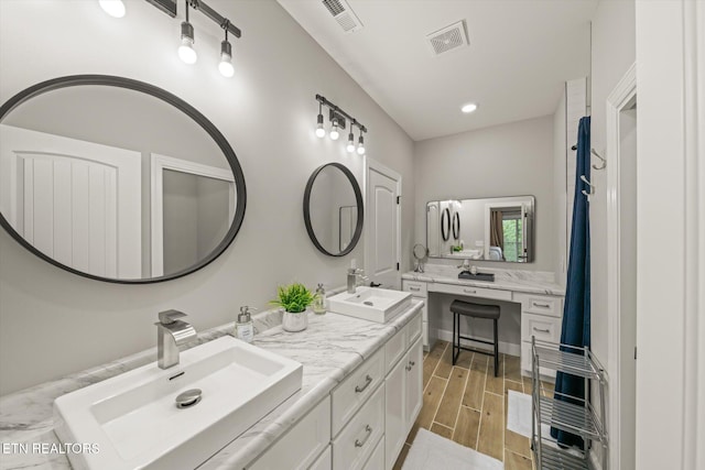 bathroom featuring hardwood / wood-style flooring and vanity