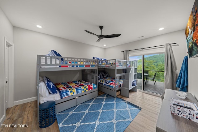 bedroom with ceiling fan, hardwood / wood-style flooring, and access to exterior