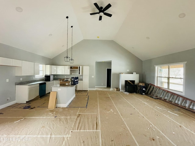 kitchen with dishwashing machine, high vaulted ceiling, white cabinetry, open floor plan, and a center island