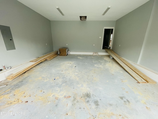 interior space with electric panel and concrete floors