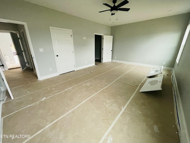 unfurnished bedroom with ceiling fan and baseboards