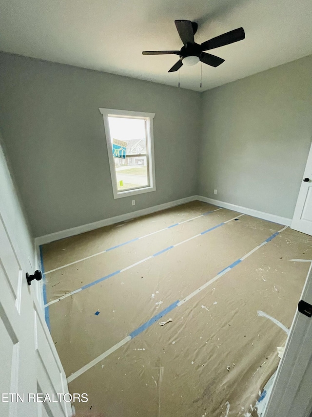 unfurnished bedroom with a ceiling fan and baseboards