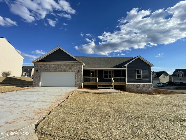 ranch-style house with driveway, an attached garage, a porch, and brick siding