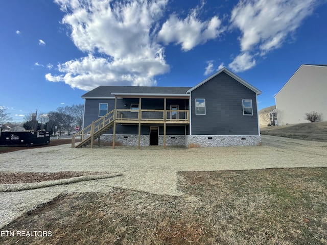 rear view of house featuring crawl space, stairway, and a deck