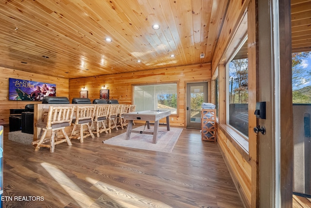 playroom with hardwood / wood-style floors, bar, wooden ceiling, and wood walls