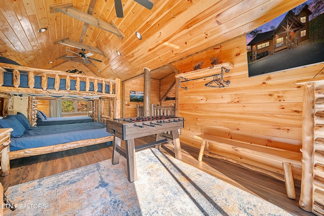 rec room featuring wood ceiling, ceiling fan, wooden walls, wood-type flooring, and lofted ceiling with beams