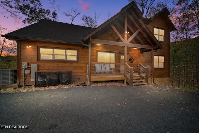 view of front facade with cooling unit and covered porch