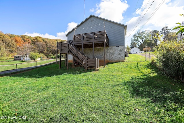 back of house featuring a yard and a deck