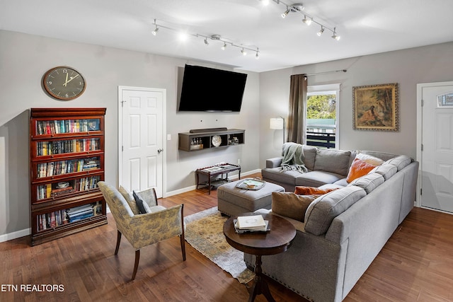 living room with hardwood / wood-style flooring and track lighting