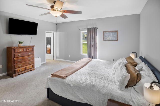 bedroom featuring ceiling fan and light carpet