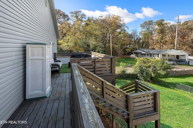 wooden deck with a lawn