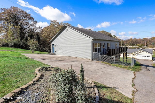 view of side of property featuring a yard and a garage